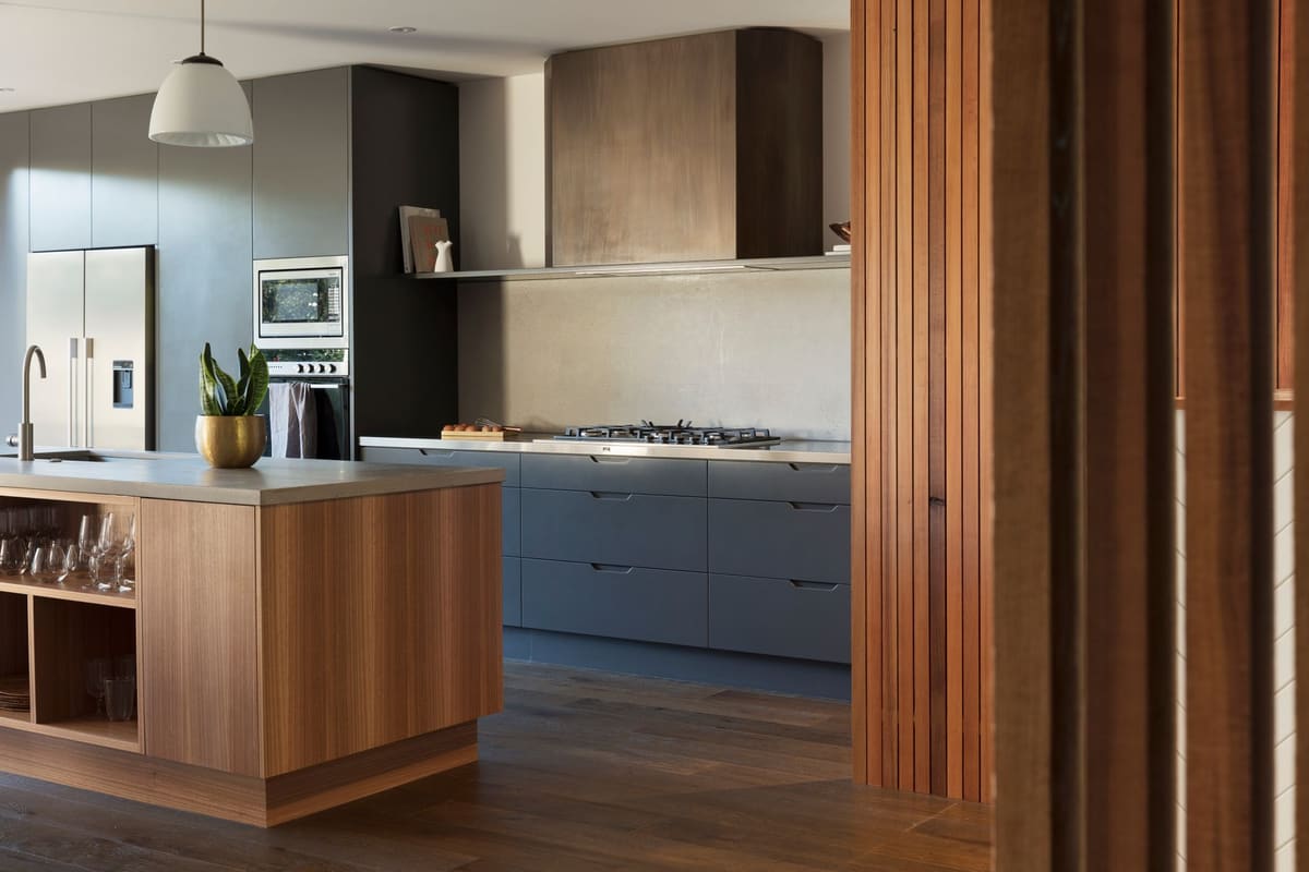 Contemporary kitchen design featuring wooden cabinets and stainless steel appliances.