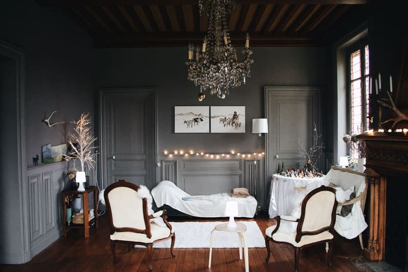 Cozy living room with classic decor and string lights creating a warm holiday ambiance.