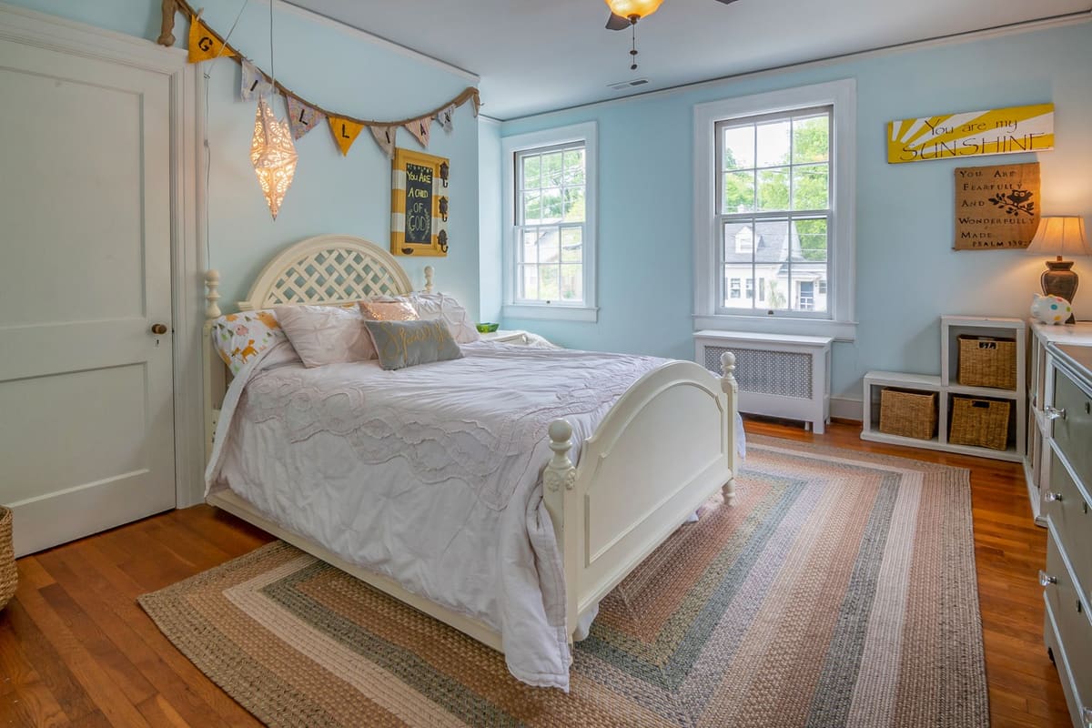 Cozy bedroom with a white bed frame and vintage decor lit softly