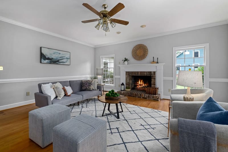Cozy living room with modern furniture and a lit fireplace, perfect for relaxing evenings.