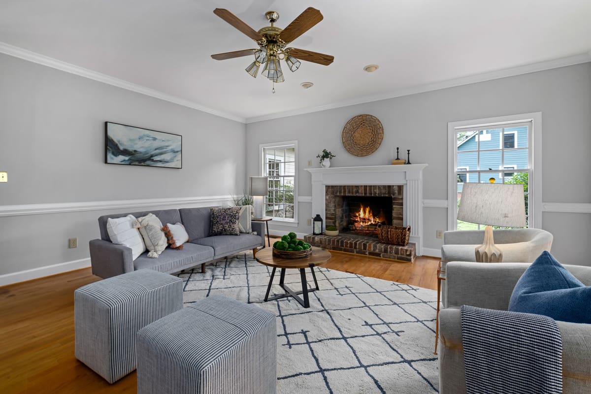 Cozy living room with modern furniture and a lit fireplace, perfect for relaxing evenings.