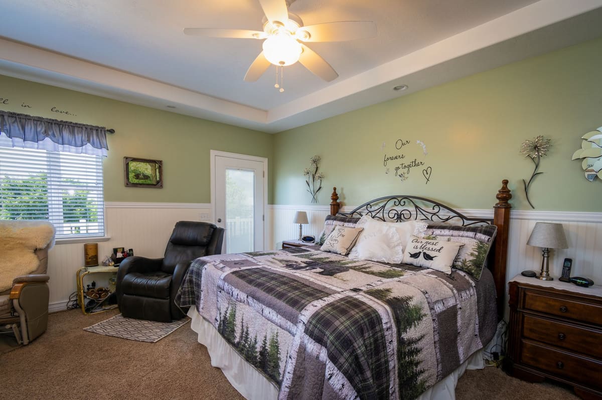 A spacious, well-lit bedroom with modern decor and comfortable bedding.